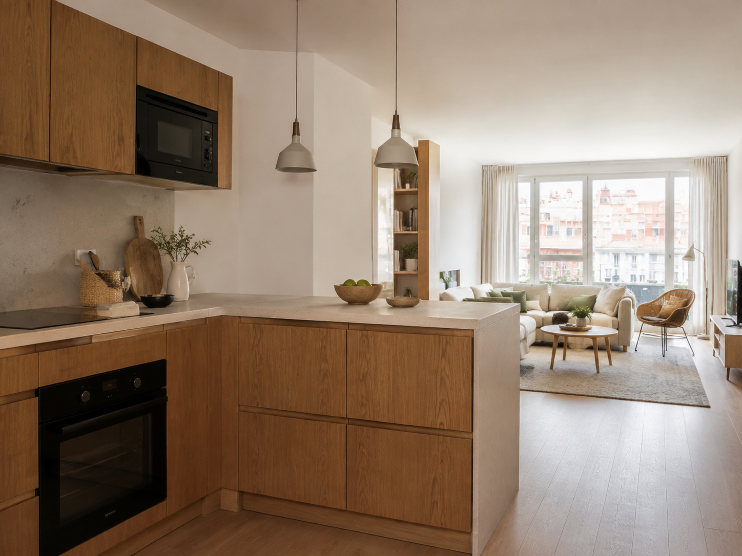 Cocina abierta al salón reformada con isla y espacio de estar integrado